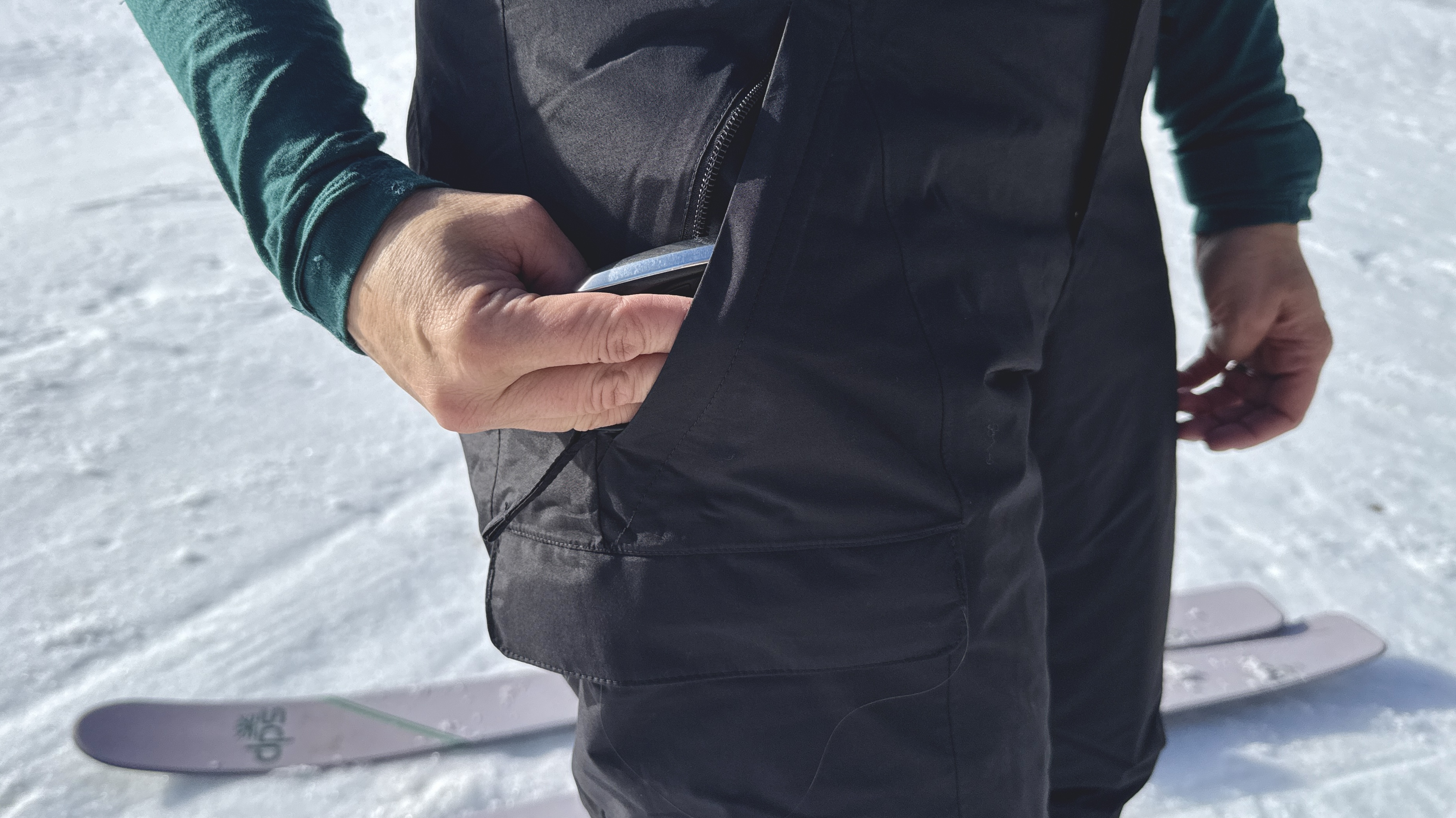 Full length view of a person standing in the snow wearing The North Face Freedom Insulated pants.