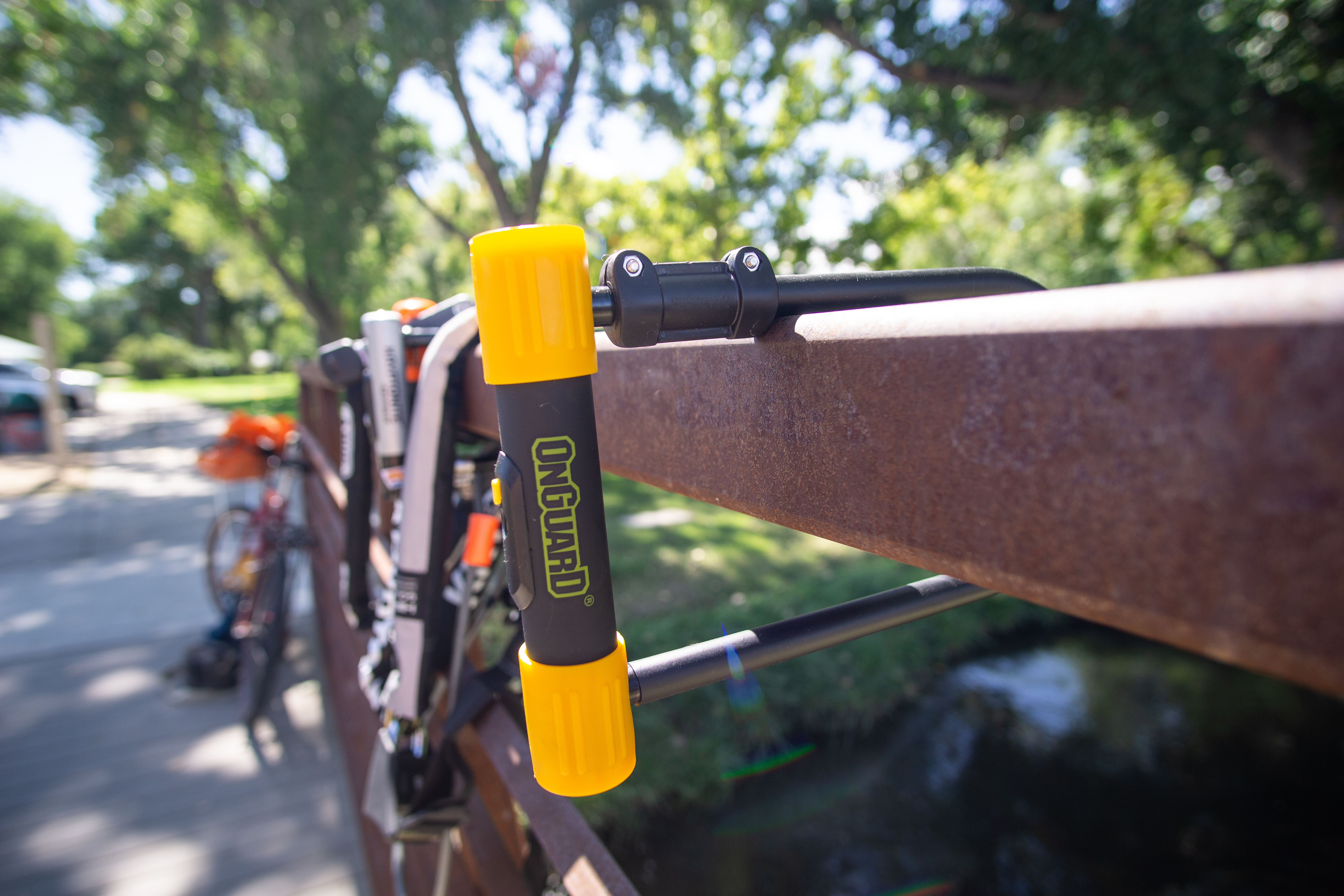 Multiple heavy-duty bike locks lined up on a wooden surface for a comparison test.