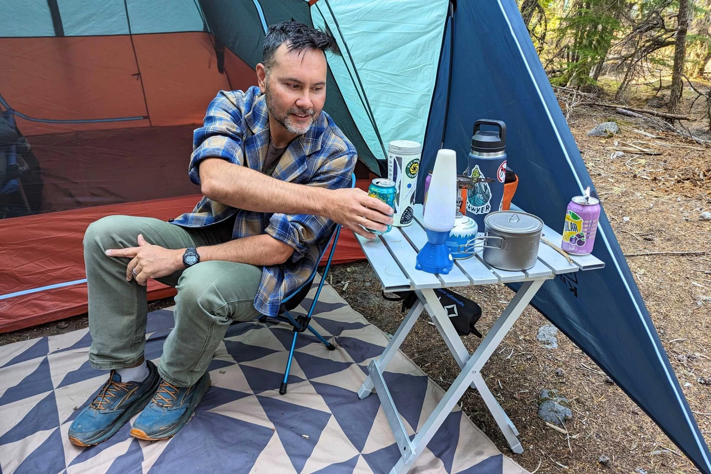 A decorative ground blanket used as a mat at the entrance of a camping tent.