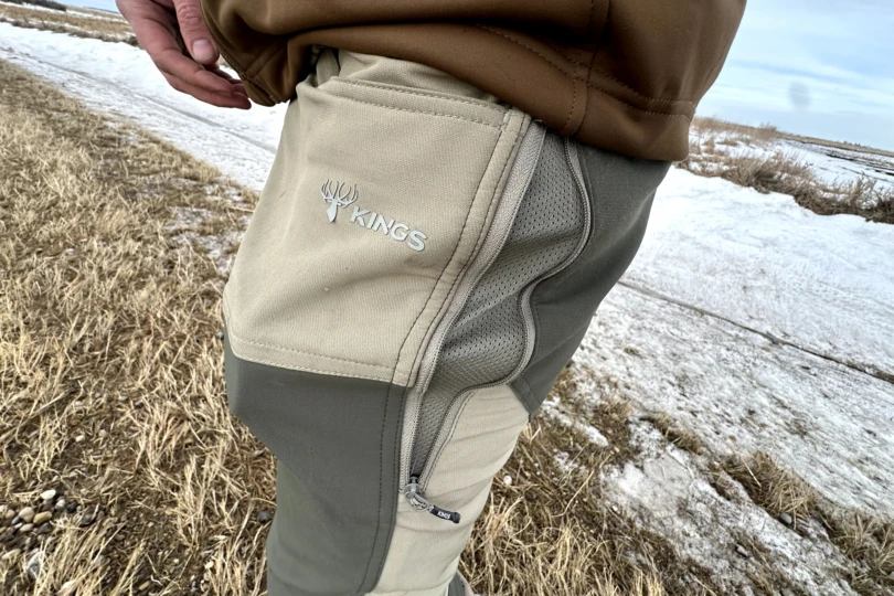 An open side zipper on the Kings Camo XKG Field Pant revealing the integrated hip vent.