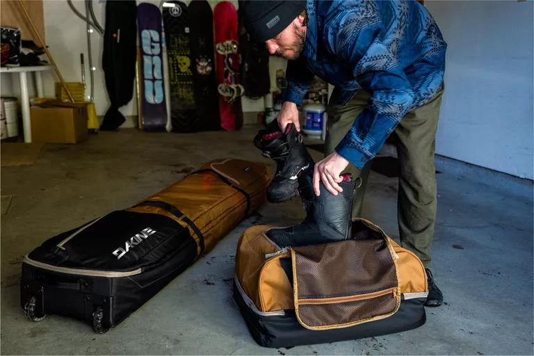 Ski trip travel gear and packing essentials including a bag and winter accessories.