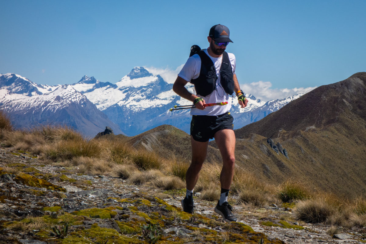 Runner wearing a Salomon Adv Skin 12 vest on a mountain trail