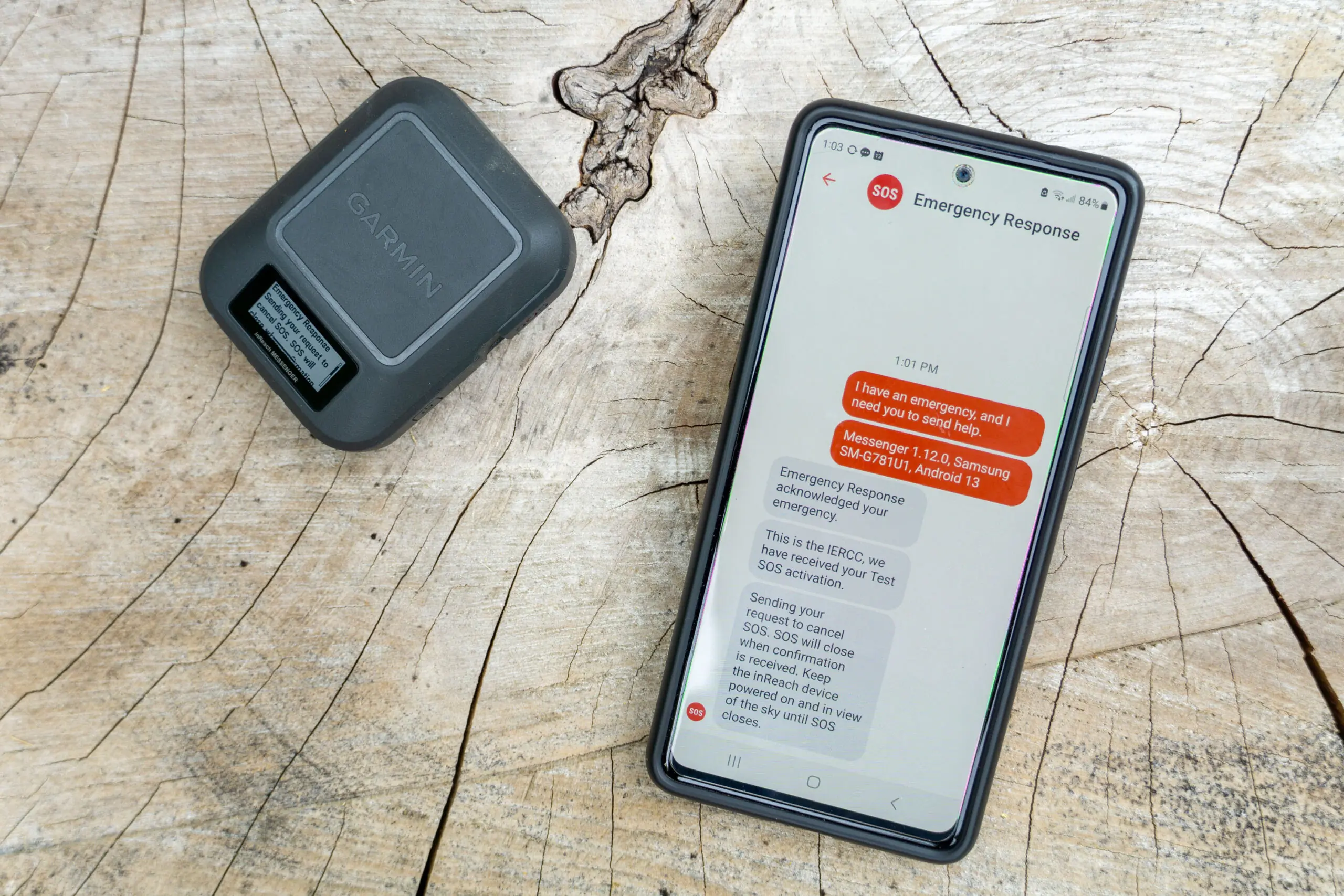 Close-up detail of the dedicated SOS emergency button on a Garmin satellite messenger.