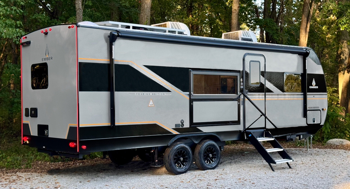 An Ember RV Touring Edition travel trailer parked in a scenic outdoor setting.
