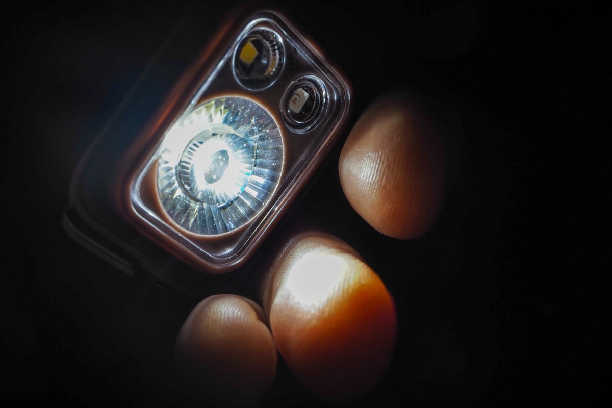 The Black Diamond Spot 400-R headlamp in a compact, orange housing.
