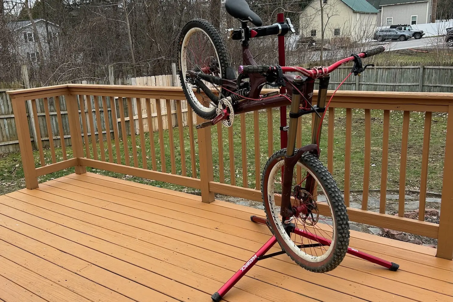 A heavy downhill mountain bike securely held by the Feedback Sports Pro Mechanic repair stand.