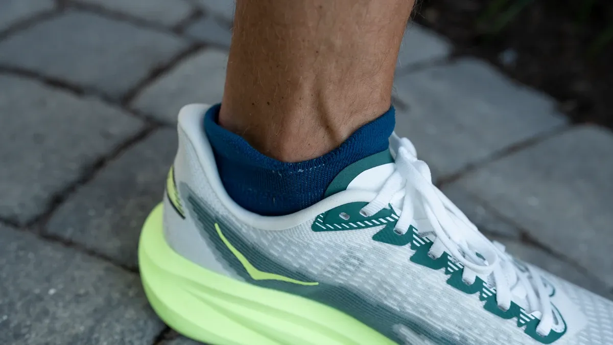 Close-up detail of the HOKA Mach 7 heel collar and the textured Creel jacquard upper fabric.