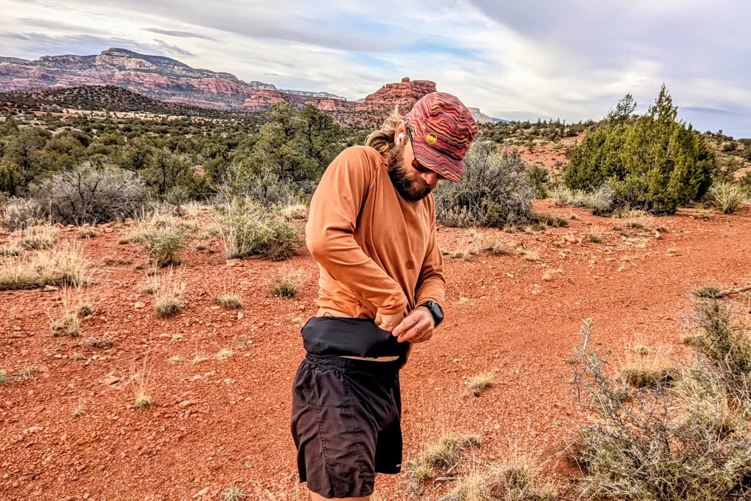 Action shot of the Ultimate Direction Utility Belt being worn during a trail run.