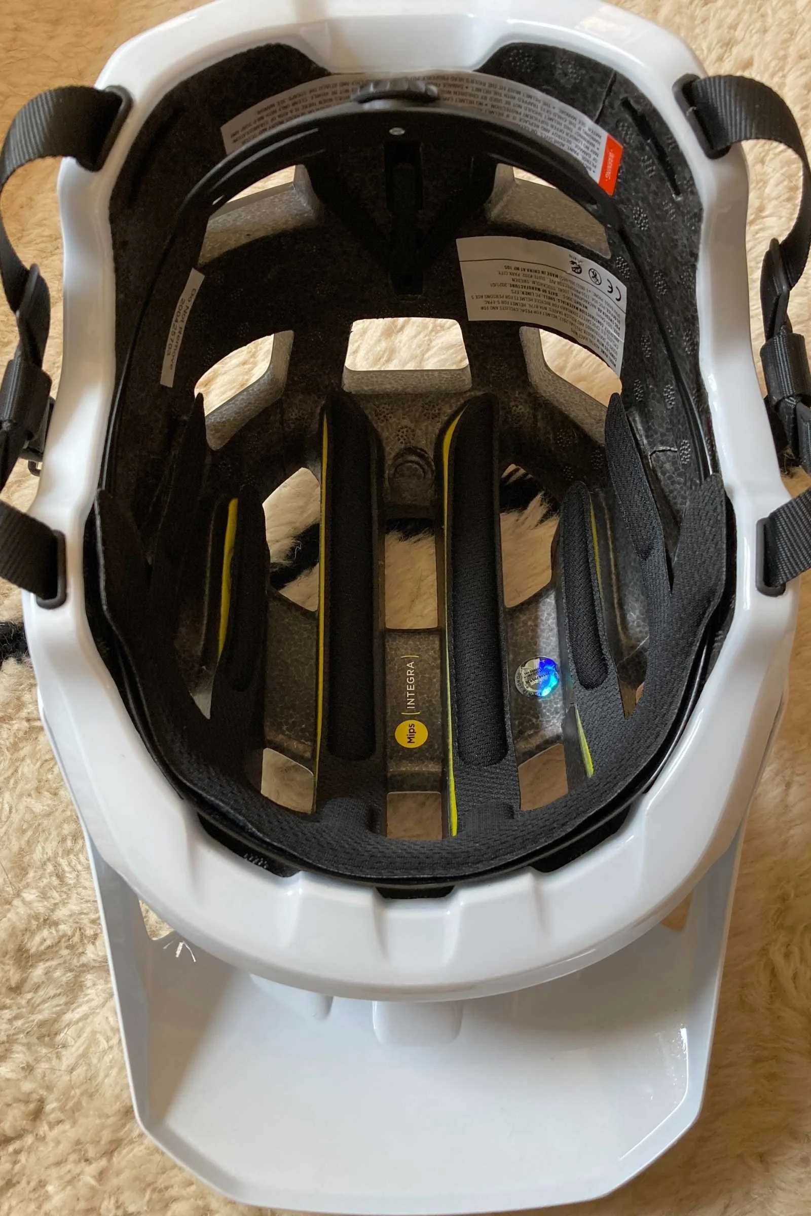 Interior view of a helmet showing the yellow MIPS Integra rotational protection liner.