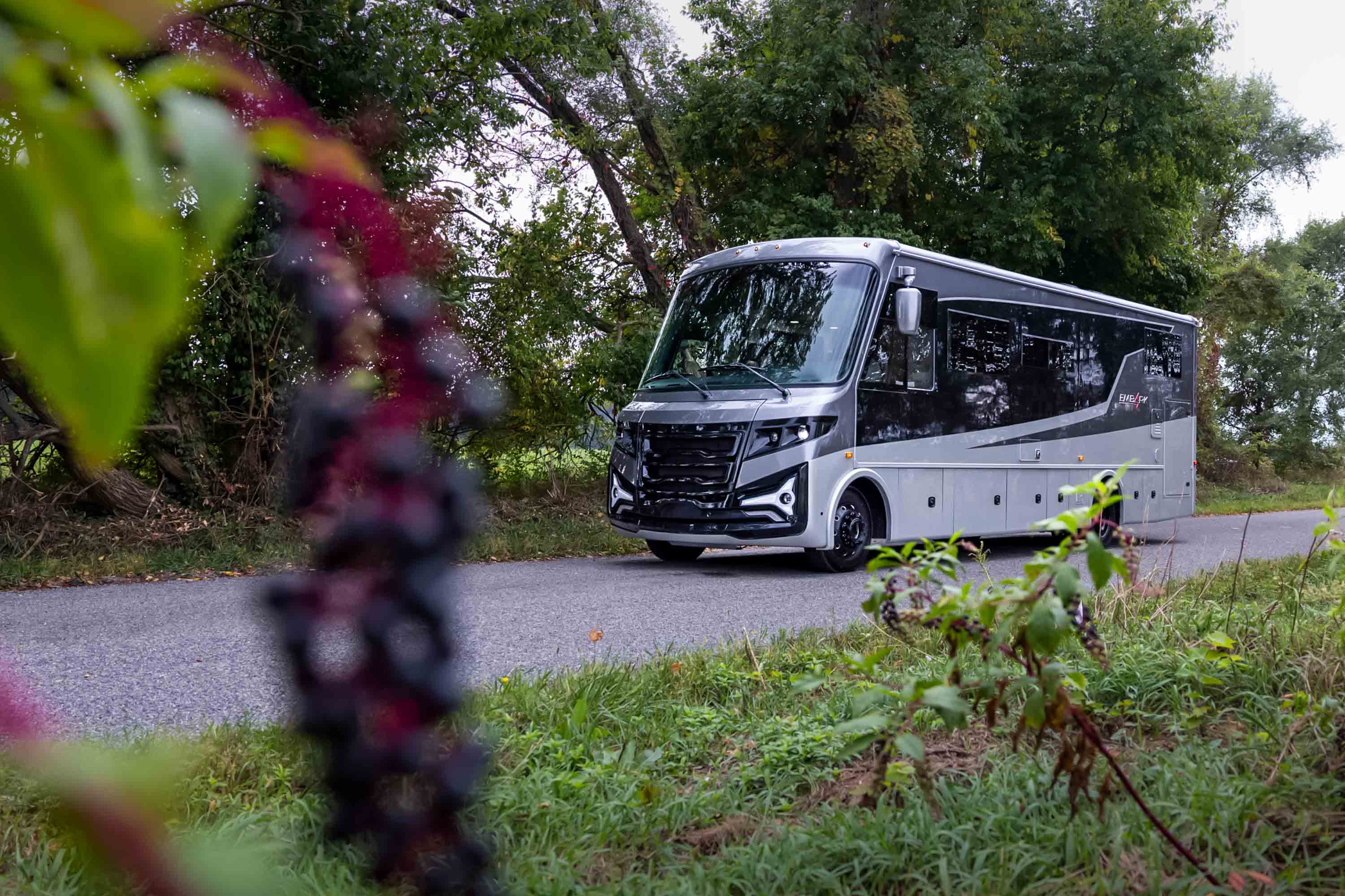 The Entegra Embark RV parked in a scenic location during a vibrant sunset.