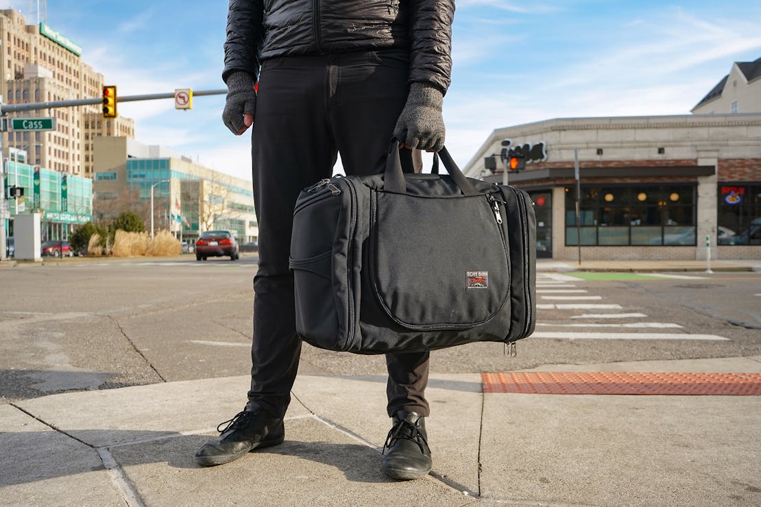 Tom Bihn Aeronaut 45 duffel bag being carried by its side handle like a briefcase.