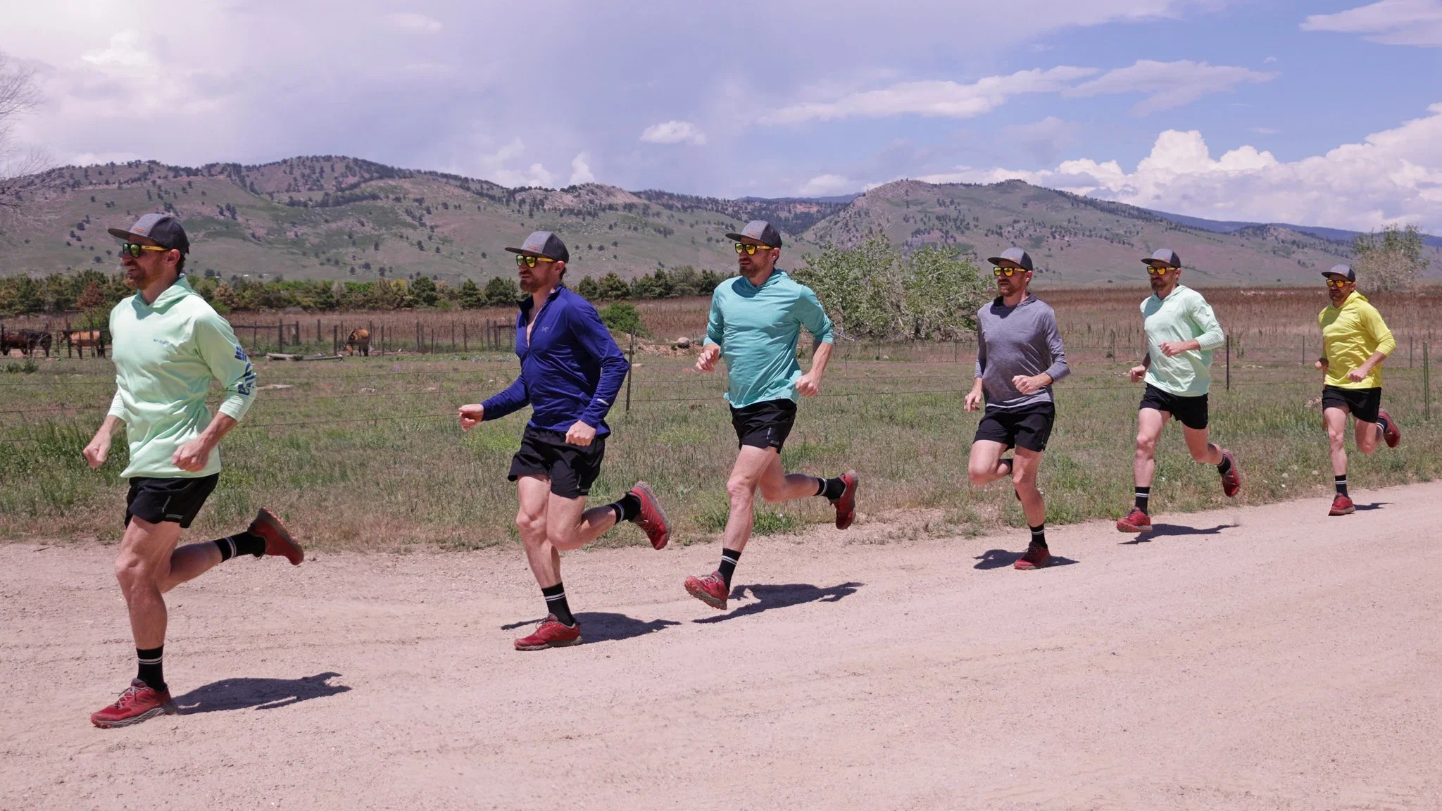 A tester running uphill in a hooded sun shirt to evaluate high-activity performance.