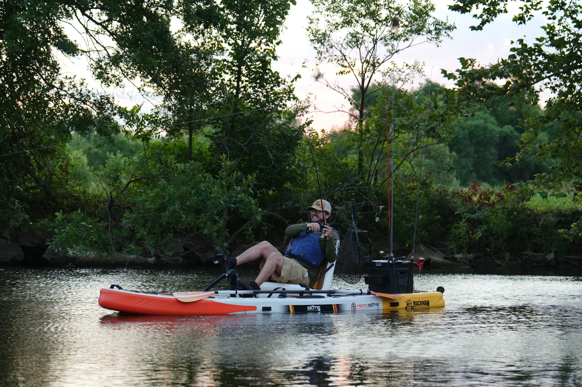 A man navigating a kayak in open water while fishing.