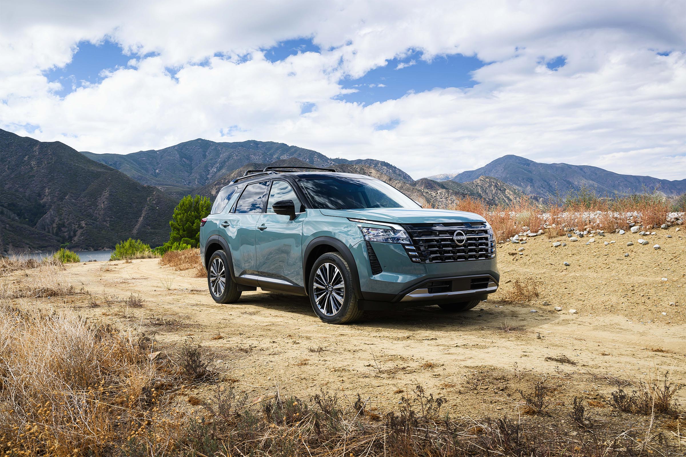 A low-angle front view of the 2026 Nissan Pathfinder against a clear blue sky.