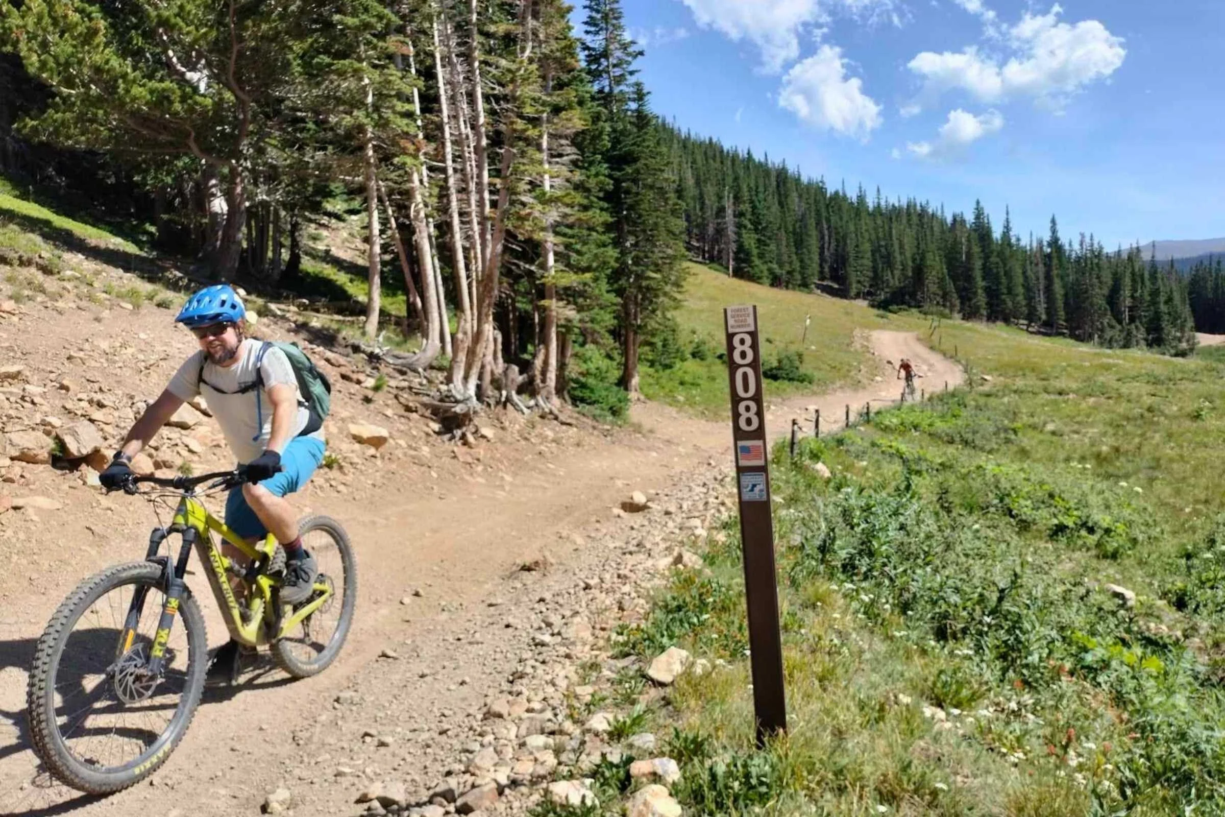 A mountain biker riding at Rollins Pass wearing Patagonia Dirt Roamer shorts.