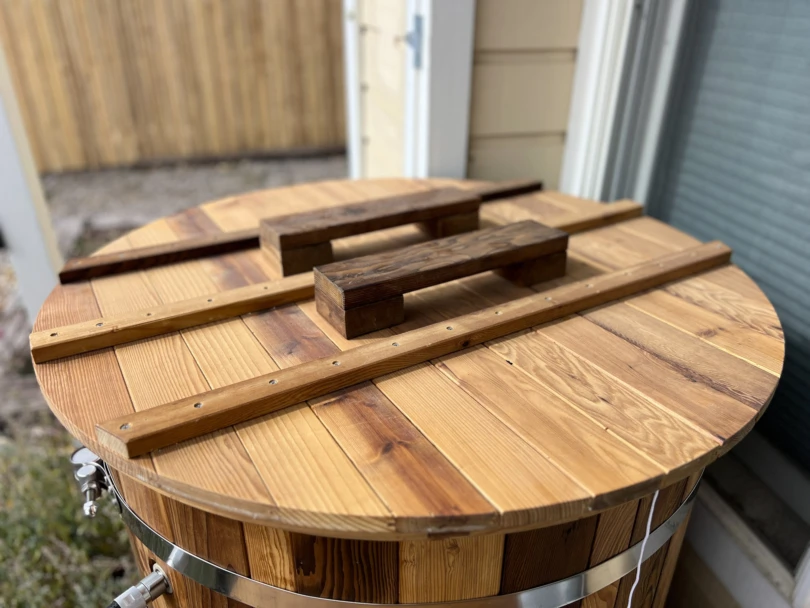 Top view of the thick wooden lid for a cold plunge tub showing the sturdy handles.