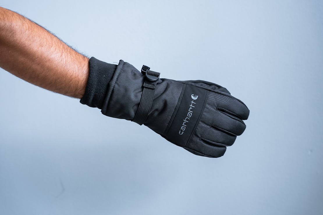 A pair of black and tan Carhartt Waterproof Insulated gloves.