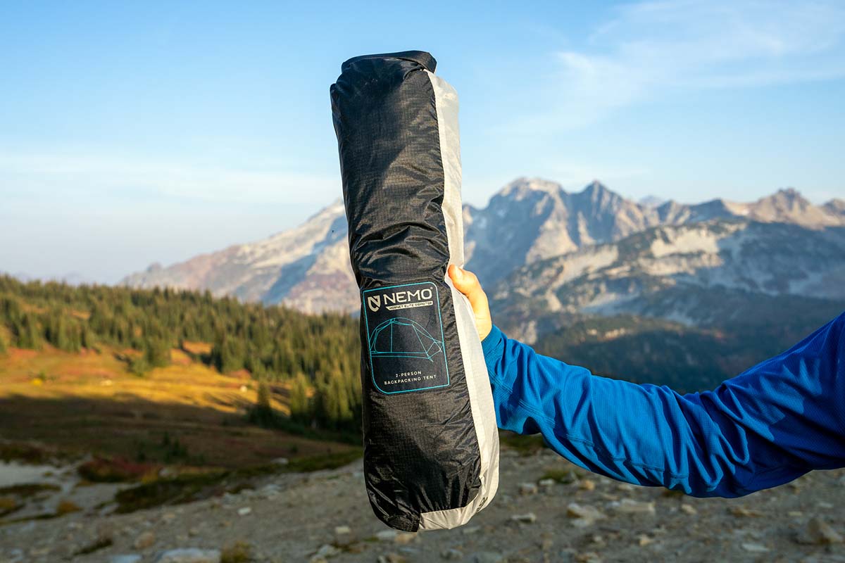 A person holding the packed Nemo Hornet Elite Osmo tent in one hand to show its small size.