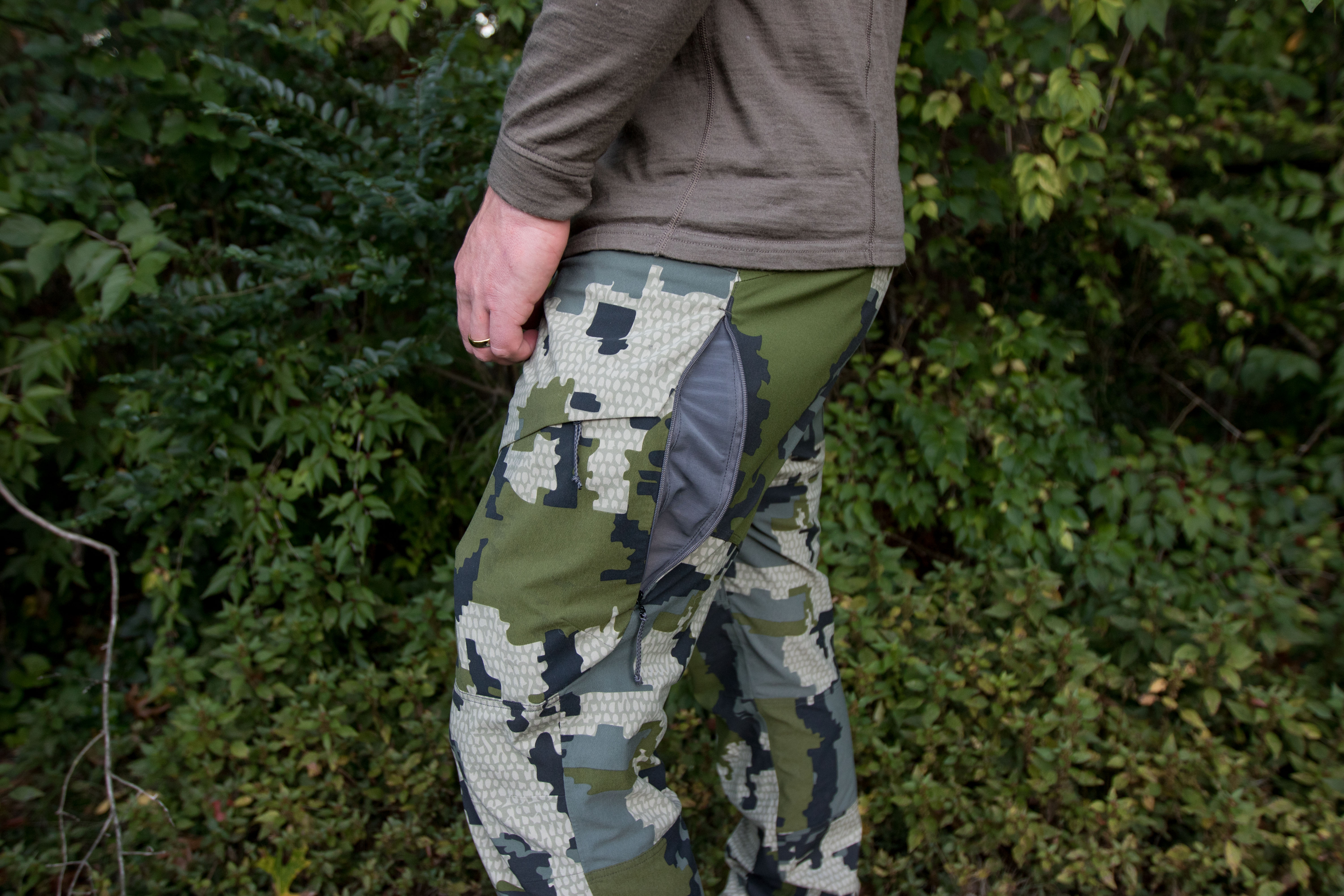 Close-up of unzipped hip ventilation zippers on a pair of hunting pants.