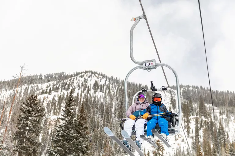 Ski rental equipment being fitted for a customer in a ski shop.