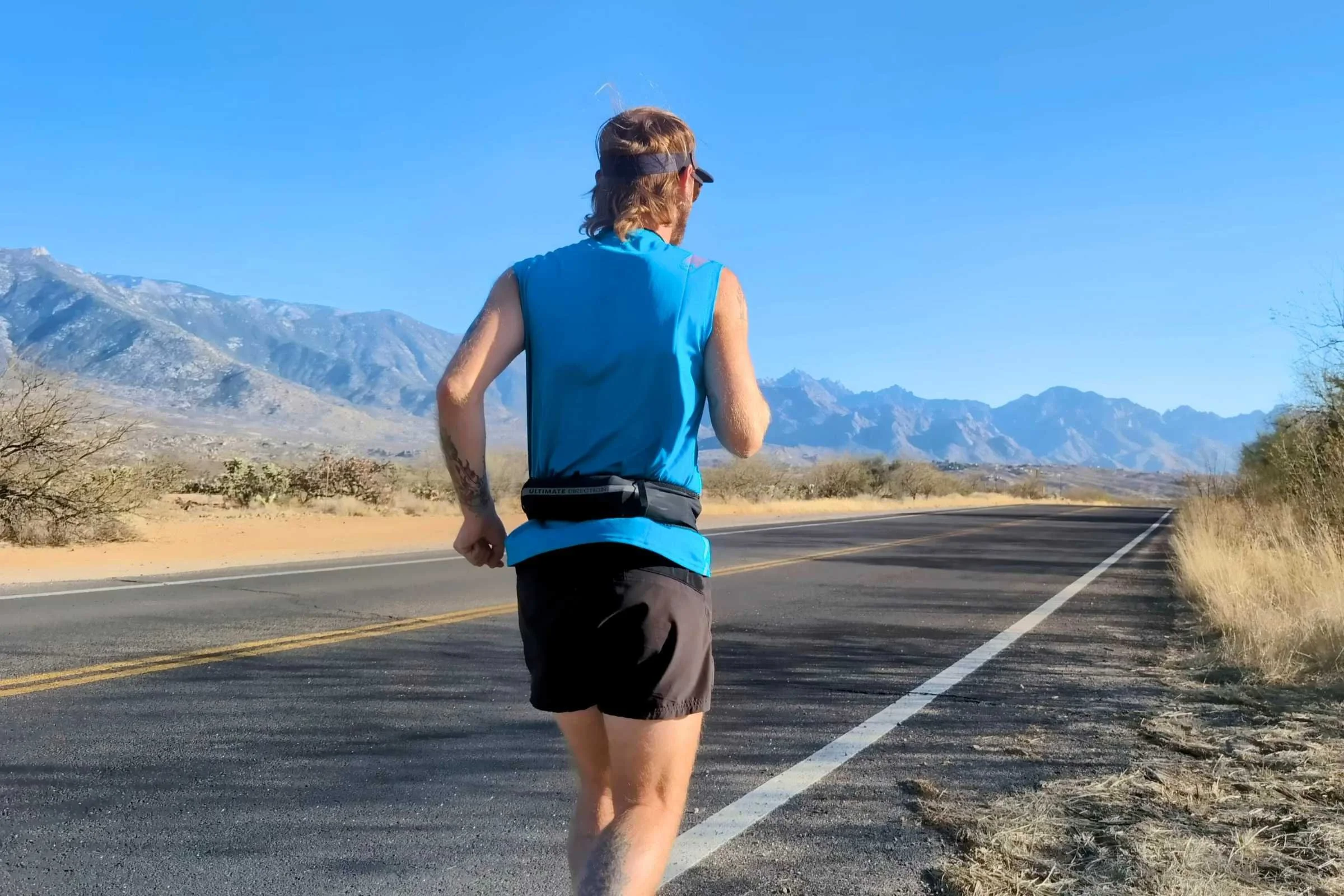 Close-up of a running belt positioned low on the hips for stability.