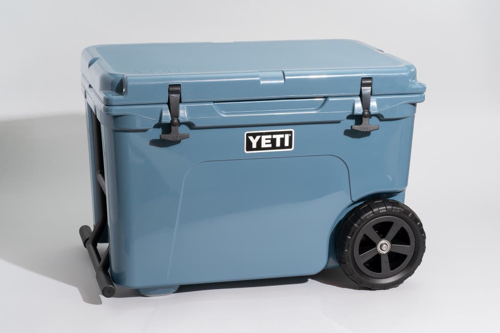 A blue Yeti Tundra Haul wheeled cooler with a heavy-duty metal handle