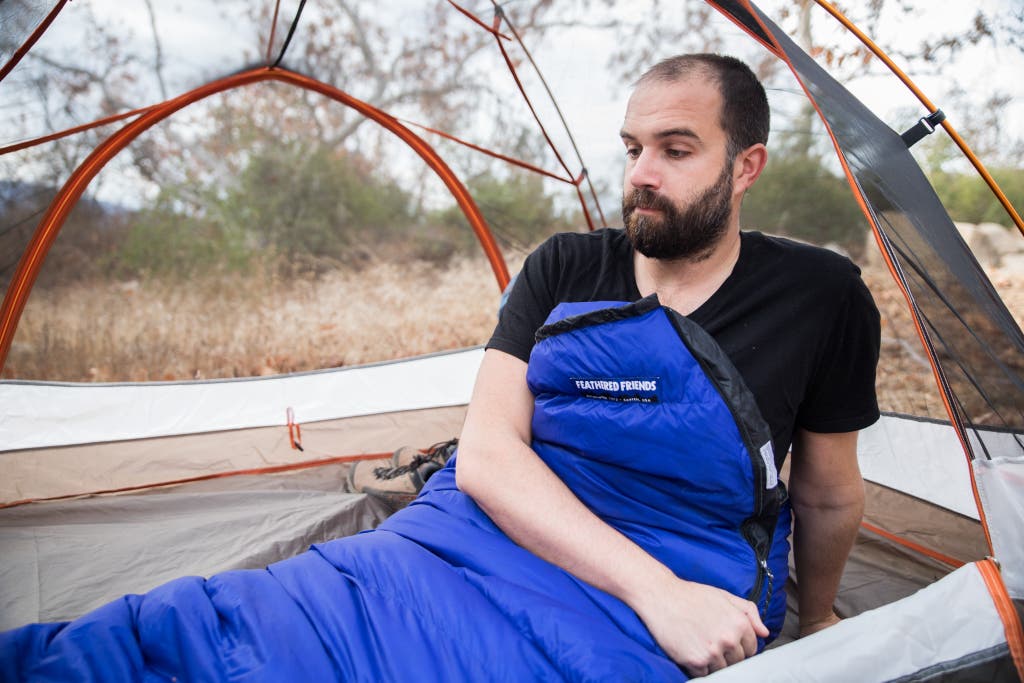 A camper using a Feathered Friends Swallow YF sleeping bag.
