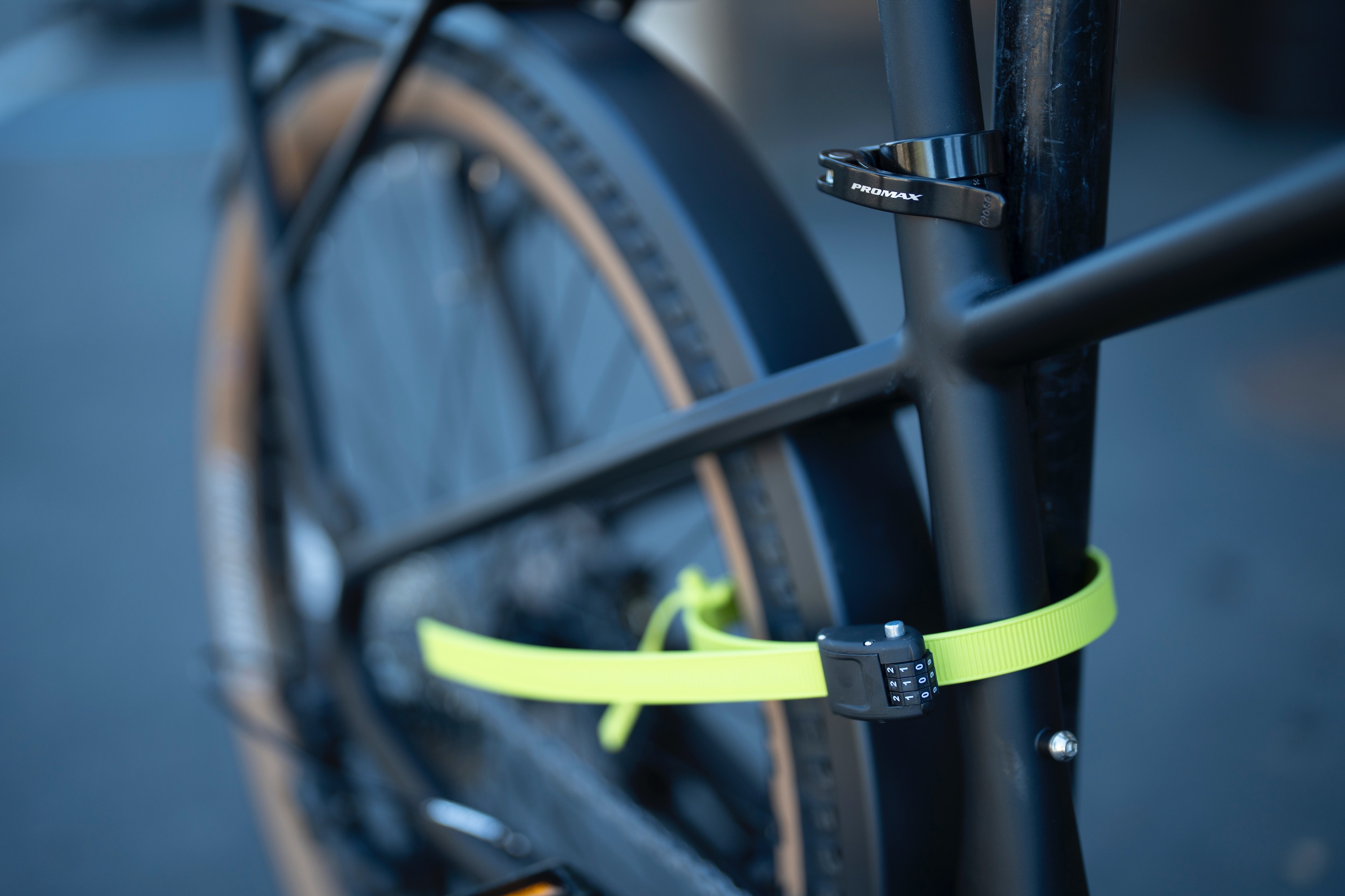 A bicycle secured with a lightweight Ottolock Original Cinch strap lock.
