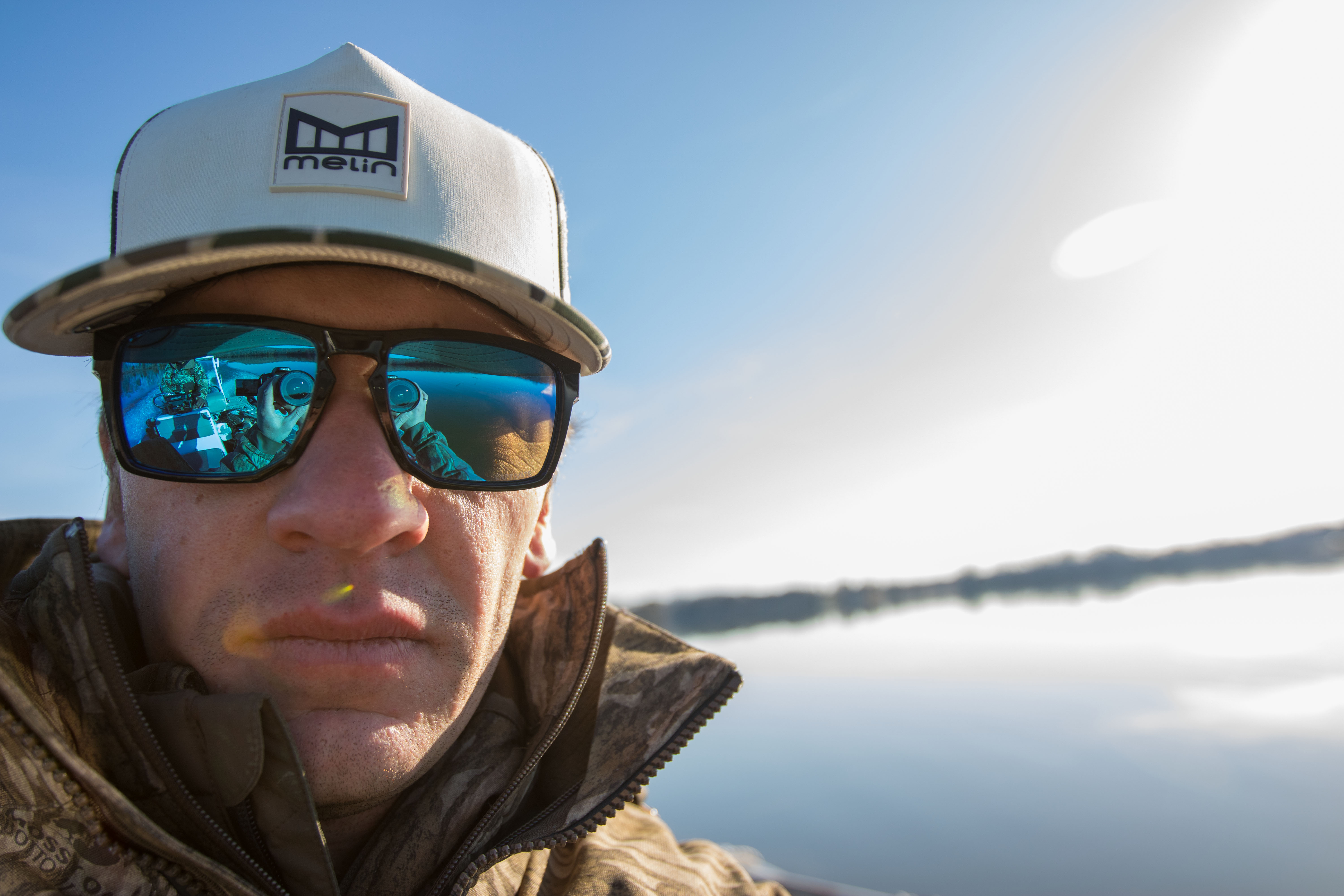 An angler wearing Wiley X Apex sunglasses while on a boat.