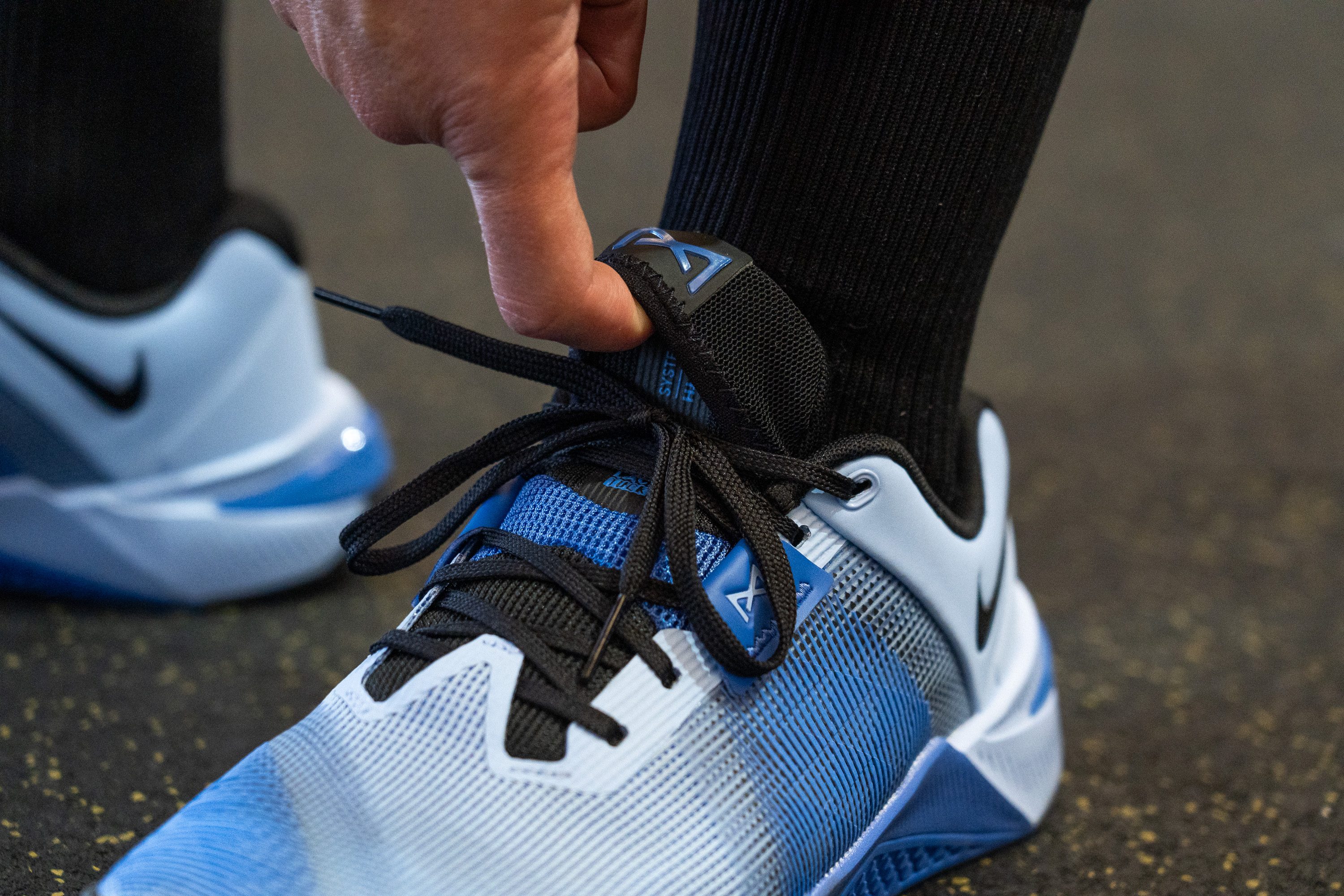 A close-up view of the shoe tongue showing how the laces are tucked into the new dedicated pocket.