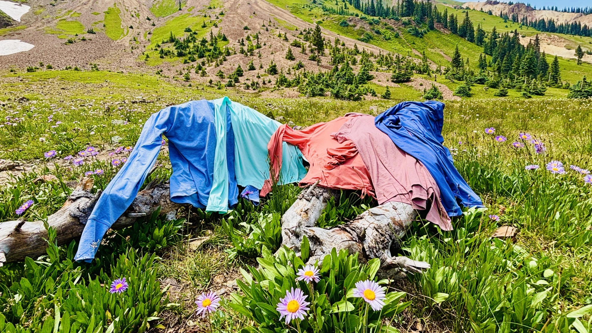 Multiple hikers wearing different sun shirts side by side on a trail.