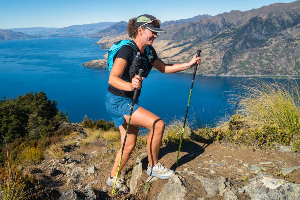 A runner's feet wearing low-cut athletic socks on a mountain path.