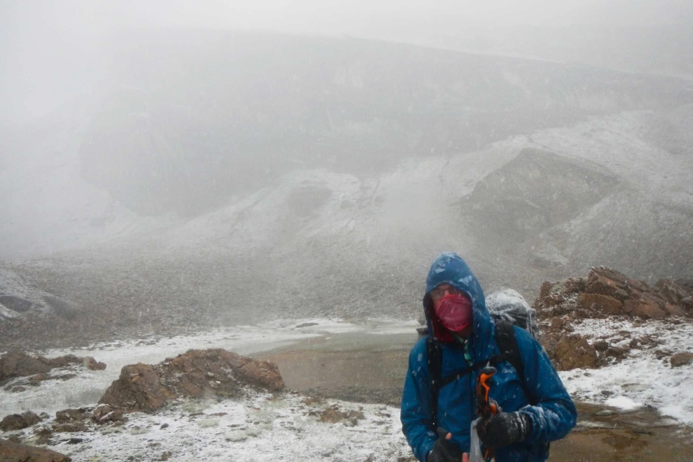 A Nikon Coolpix camera covered in snow and ice during a winter hike.