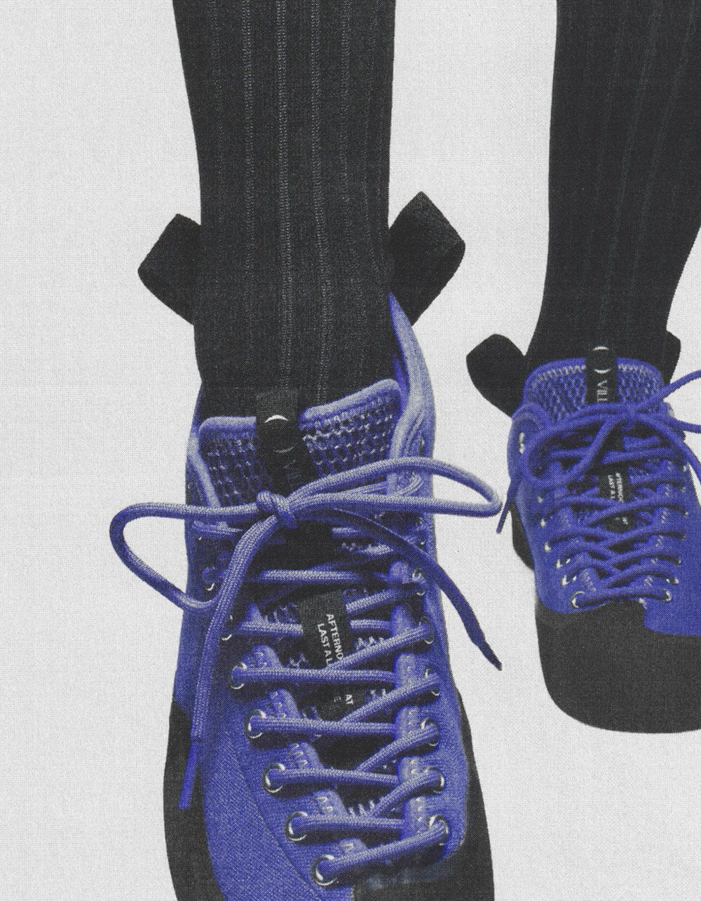 A close-up of technical outdoor-inspired skate shoes featuring heavy rubber reinforcement.