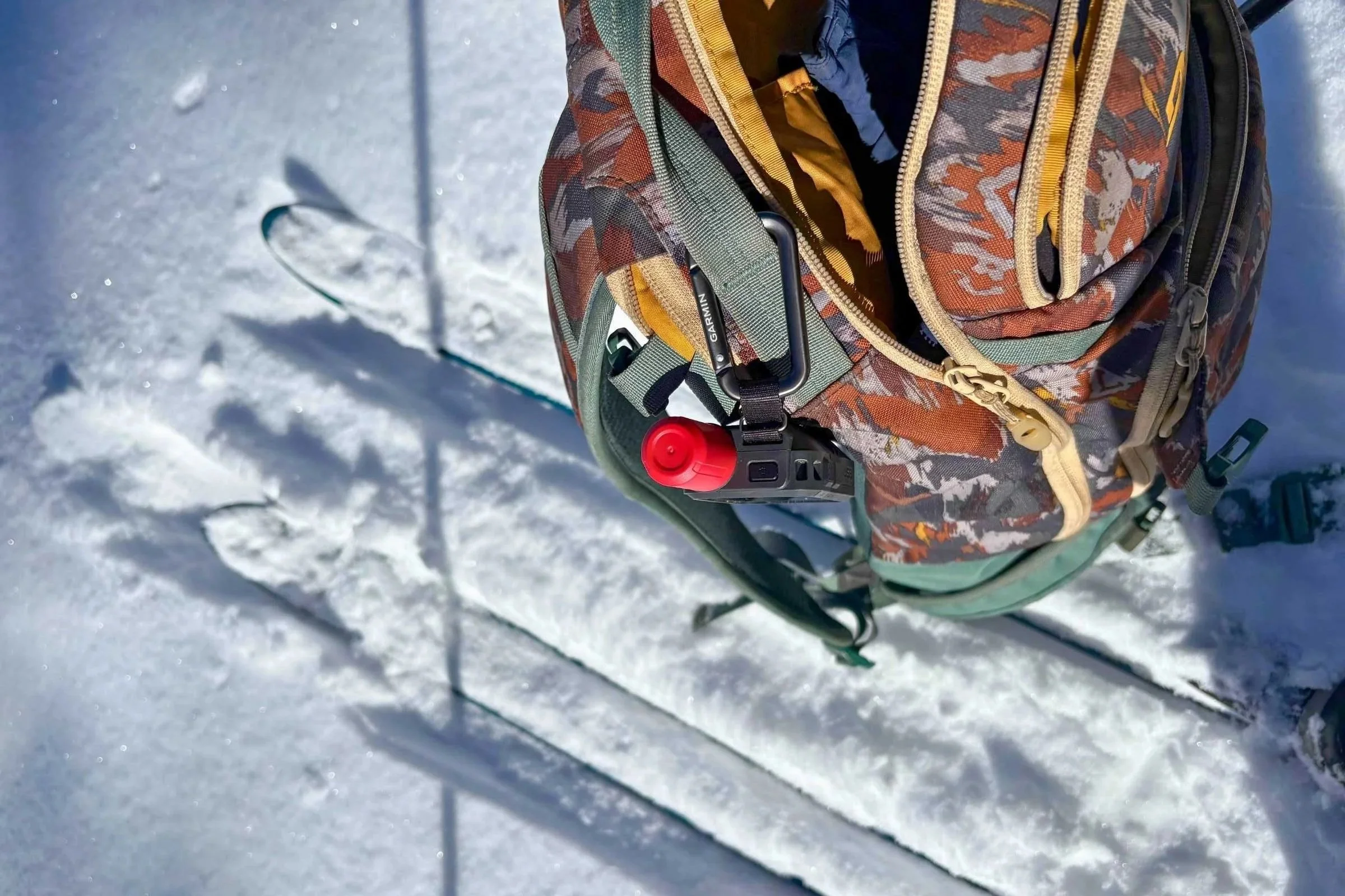 Close-up of the Garmin inReach Mini 3 Plus highlighting its rugged body and red antenna.