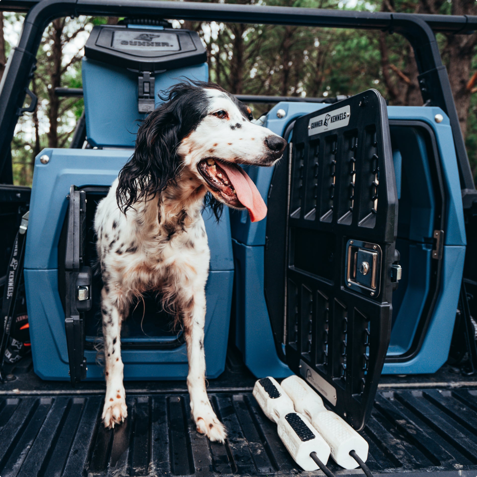 A tan Gunner heavy-duty rotomolded dog kennel.