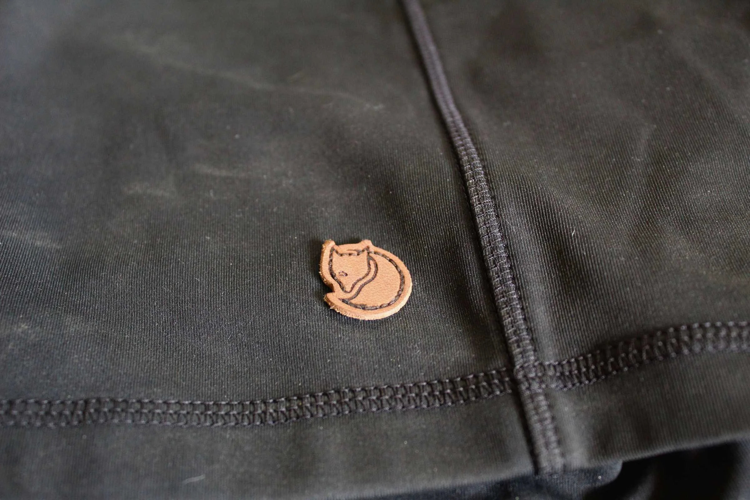Close-up of the leather fox logo on the side of a pair of Fjallraven shorts.