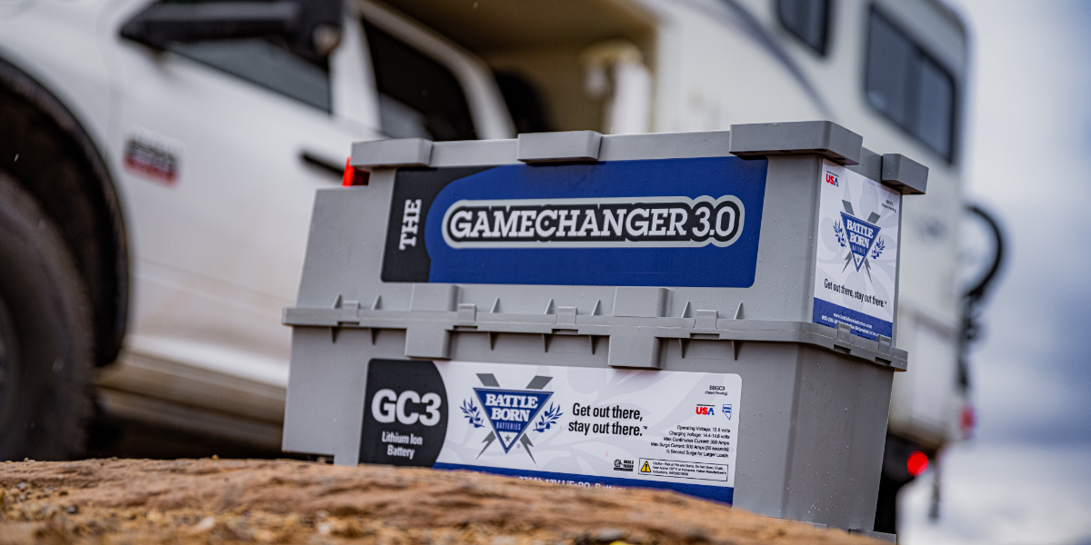 A row of blue Battle Born lithium-ion batteries installed in an RV storage compartment.