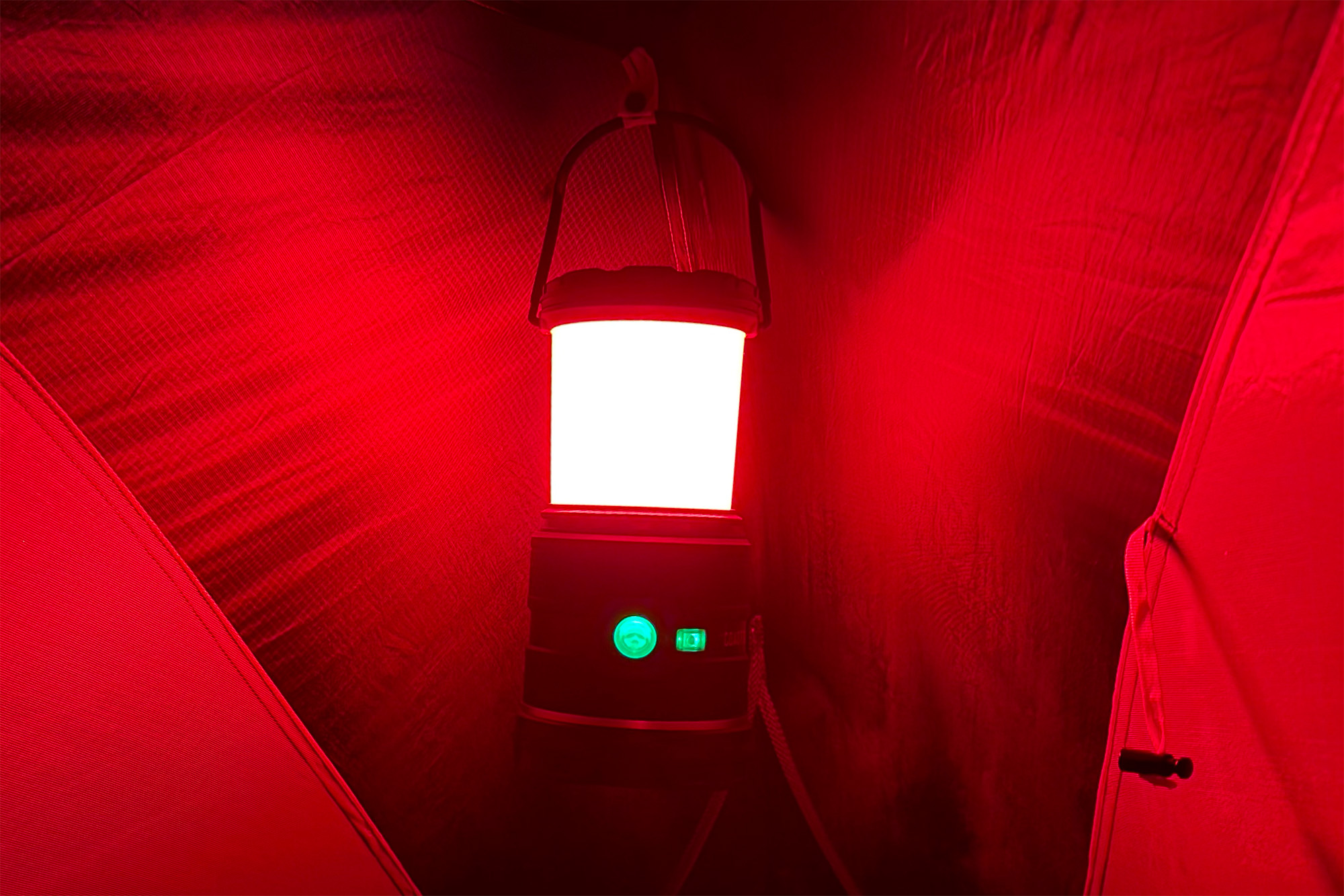 The COAST EAL35R lantern glowing with a red light mode.