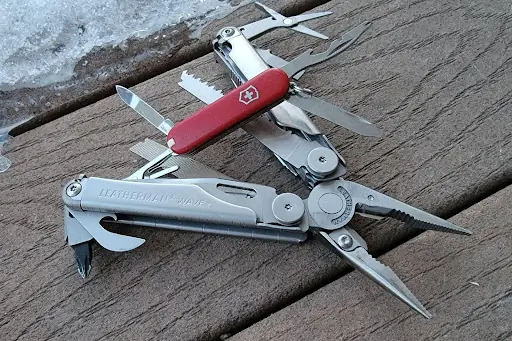 Detailed macro shot of various multitool components, hinges, and steel textures.