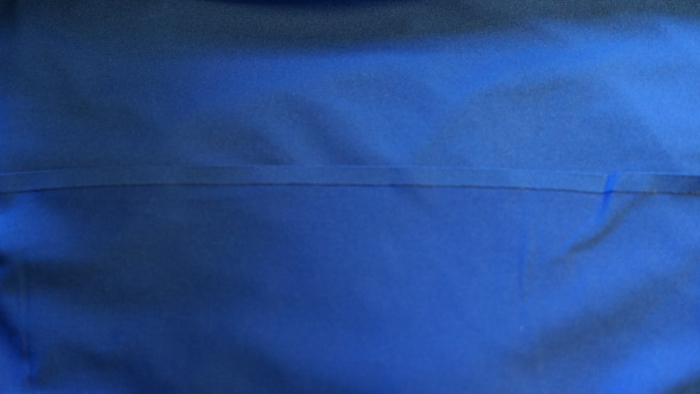 Extreme close-up of flatlock seam construction on an Arc'Teryx running shirt.
