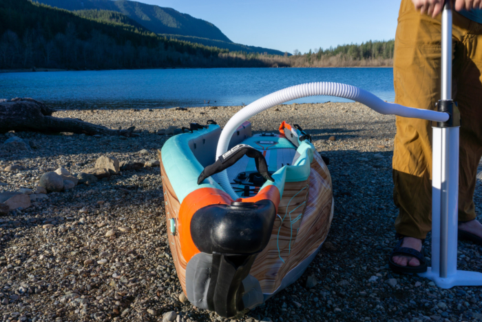 A close-up view of a high-pressure Halkey-Roberts valve on the side of an inflatable kayak.