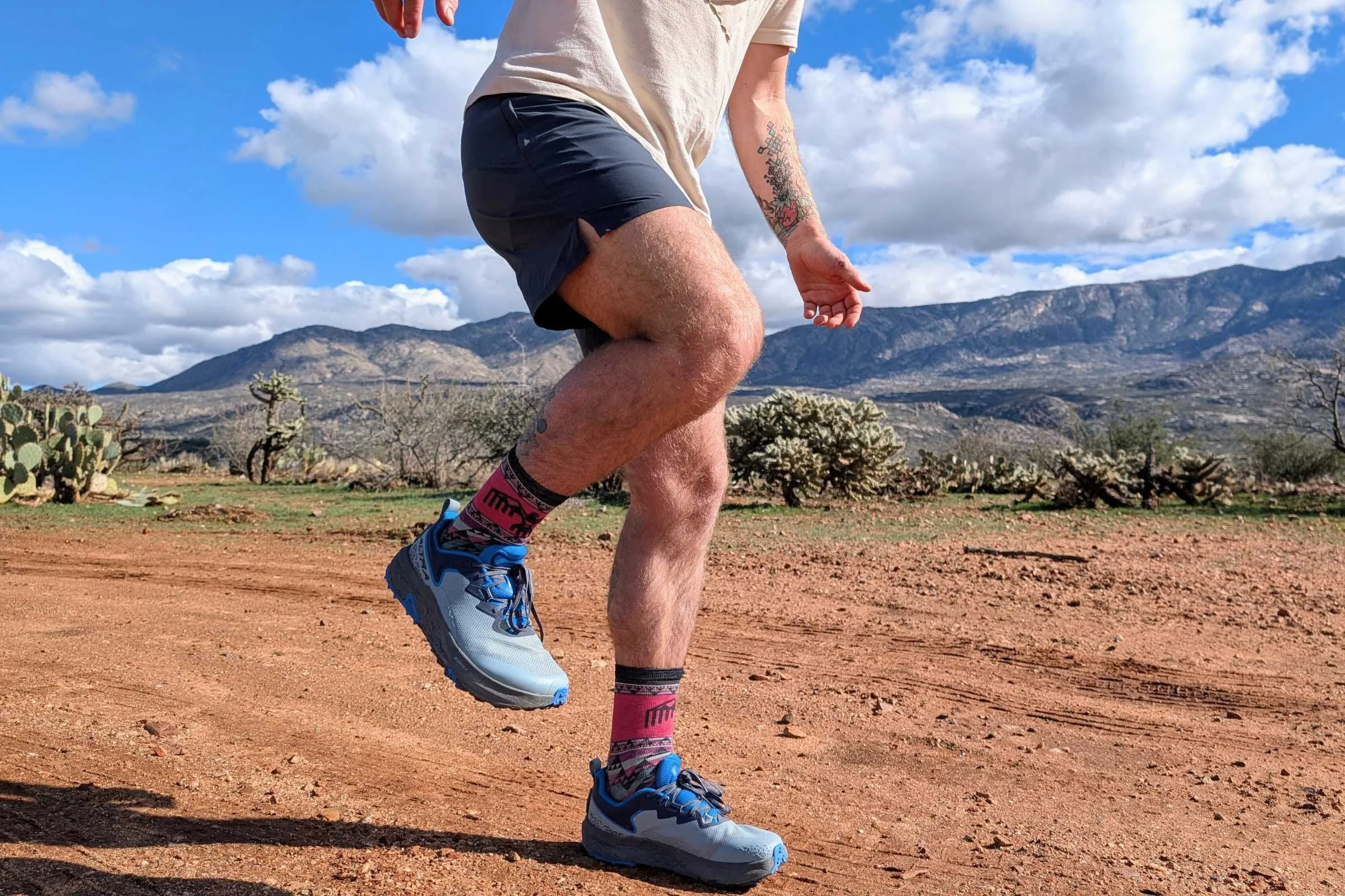 Tester running on a dusty trail in Arizona wearing the Altra Timp 6.