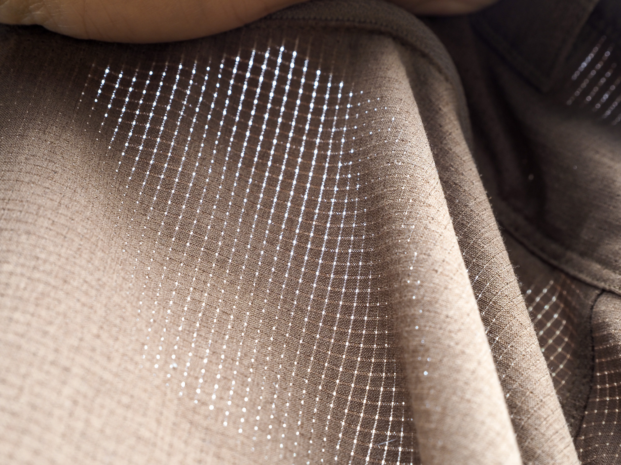 Extreme close-up detail of the lightweight, breathable fabric of First Lite Trace hunting pants.