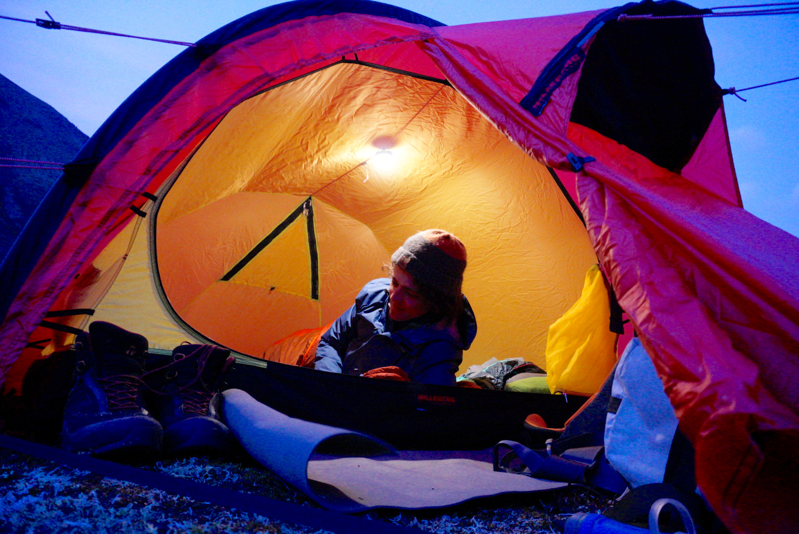 A Black Diamond Moji lantern hanging inside a tent.