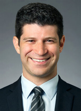 Portrait of Dr. Elan Goldwaser, a sports medicine specialist, in a clinical setting.