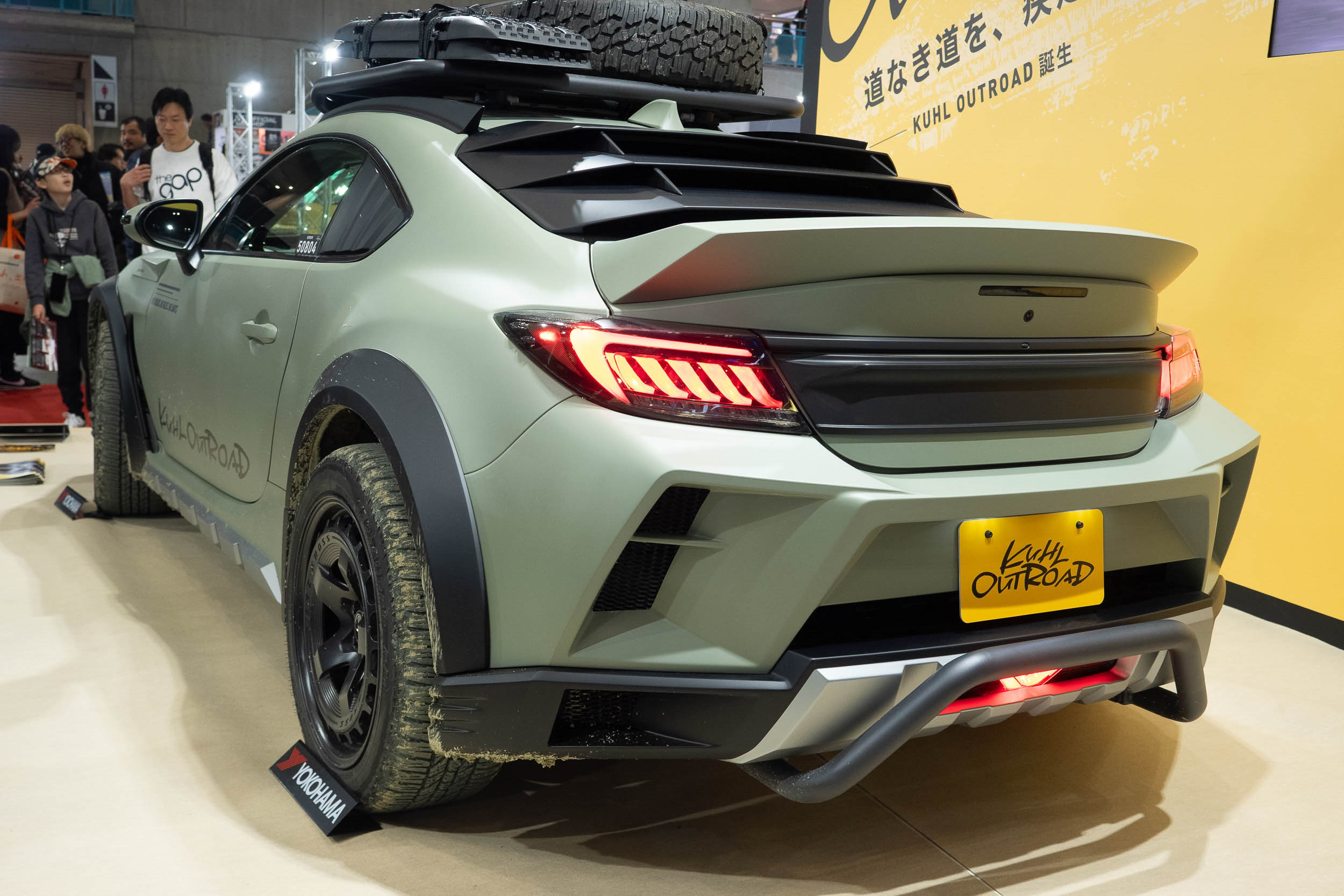 A white Kuhl Outroad GR86 with a lifted suspension, widebody kit, and all-terrain tires.