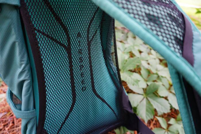 Close-up of a mesh-covered tensioned back panel on a hiking backpack.