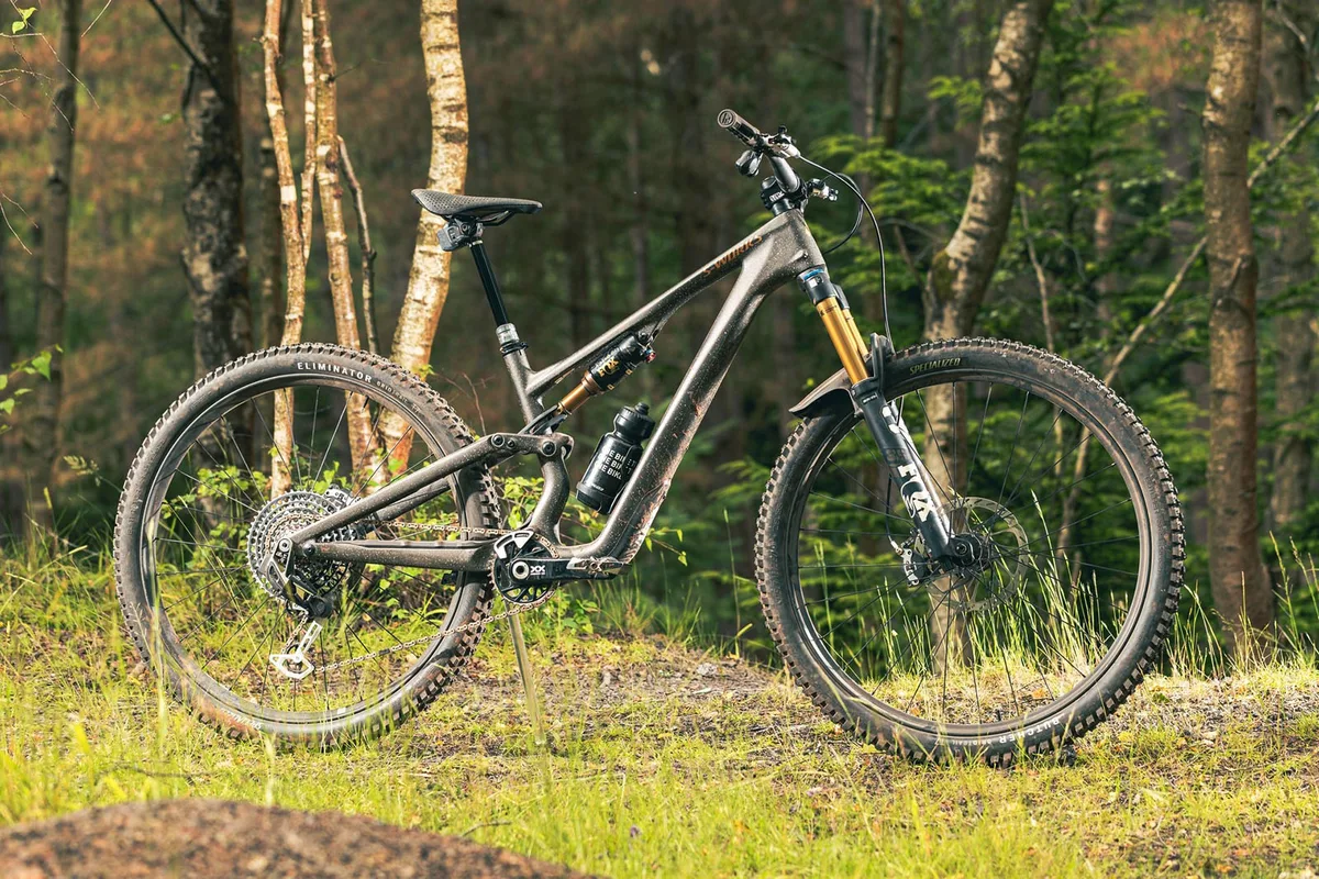 Side profile of the Specialized S-Works Stumpjumper 15 mountain bike featuring carbon frame and GENIE technology.