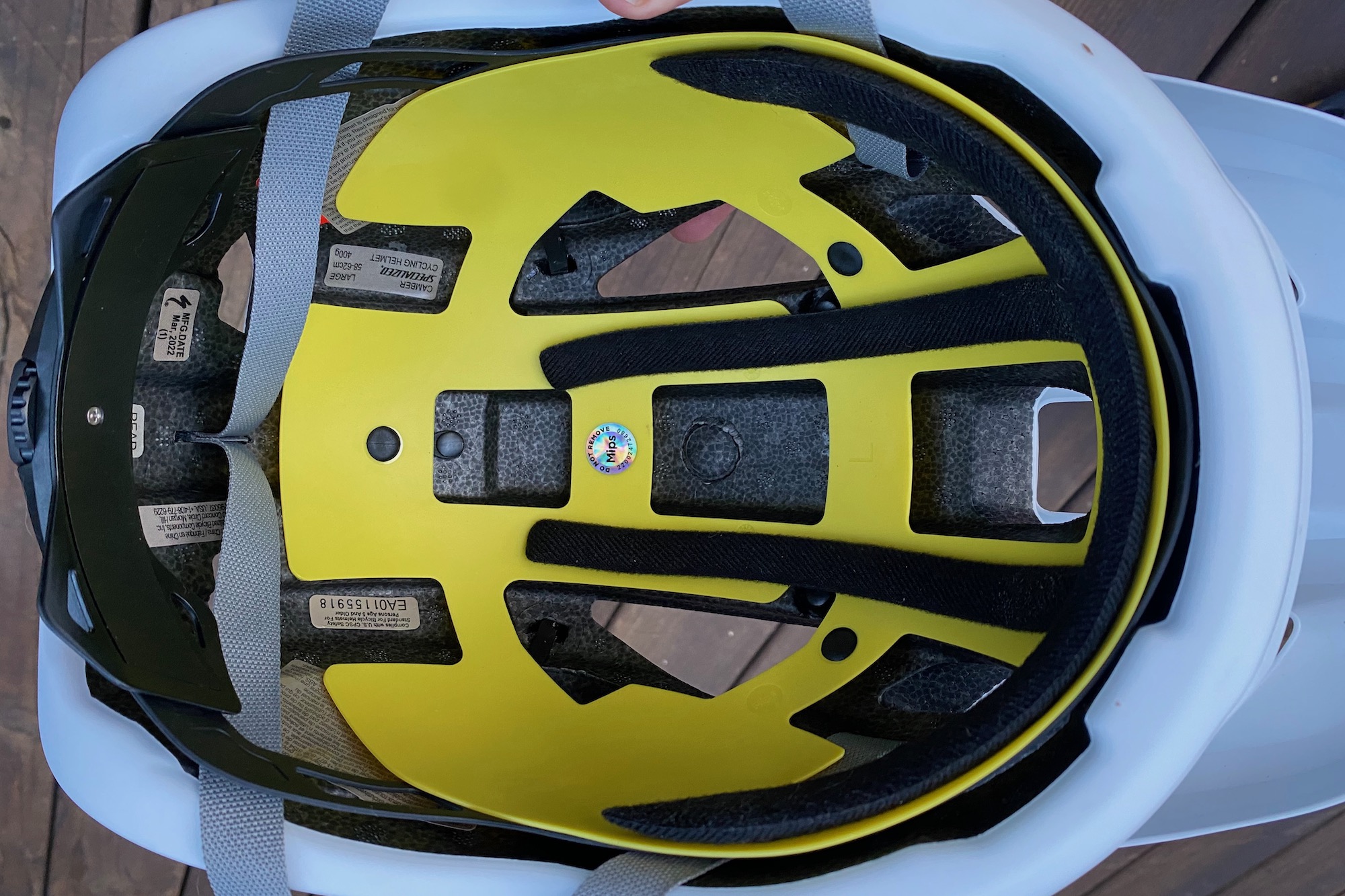 Internal view of a bicycle helmet showing the yellow MIPS plastic liner.